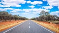 Straight road with white lines in middle of outback red centre Australia Royalty Free Stock Photo