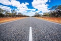 Straight road with white lines in middle of outback red centre Australia Royalty Free Stock Photo