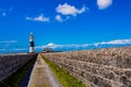 Straight rural road between limestone fences in the direction of the lighthouse in Inis Oirr island