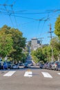 Straight sloped street with cable car wires above at San Francisco, California Royalty Free Stock Photo