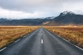 Deserted Road Runnign through Fields at the Foot of Volcaninc Mountains in Iceland Royalty Free Stock Photo