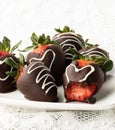 Straight on view of chocolate covered strawberries with a bite out of one.. Royalty Free Stock Photo