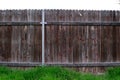 Straight view of old wooden fence between neighbors