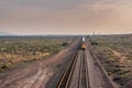 Straight on View of Train Rolling Aross Desert