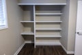 Straight on view of a white shelving system inside a closet in a bedroom Royalty Free Stock Photo