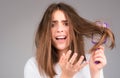 Straightening woman and treatment of the hair. Girl with straight brushed hair. Hair tangling problem. Unhappy girl with