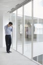 Strained Businessman Using Cellphone In Office