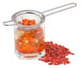 Strainer in goji berries tincture and dried fruits