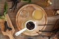 Straining homemade comfrey root ointment through a sieve, top view