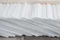 Straining at work: a Huge  stack of envelopes with a working mail on the accountant`s Desk, side view from above, tilted Royalty Free Stock Photo