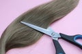 Strand of hair lie with scissors to cut Royalty Free Stock Photo
