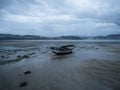 Stranded beached fishing boat vessle ship on coastline shore of seaside town village Combarro Galicia Spain at low tide
