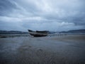 Stranded beached fishing boat vessle ship on coastline shore of seaside town village Combarro Galicia Spain at low tide