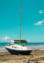 Stranded sail boat on deserted island