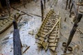 Stranded wreck of the little wooden boat with pieces of wood all around after storm