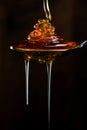 Strands of Honey Drip from Overflowing Spoon Royalty Free Stock Photo