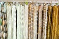 Strands of semiprecious stones on display in bijouterie store