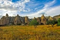 Strange, bizarre Cappadocia. Rocks of amazing shape with rounded bases rise above the yellowed grass. Royalty Free Stock Photo