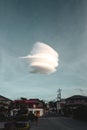 the strange cloud is floating in the sky above the street