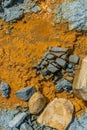 Blue rocks with orange coloured water. Royalty Free Stock Photo