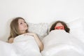 Strange couple lying in bed Royalty Free Stock Photo