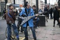 Strange funny musician sings in front of teenagers on the corner of Brick Lane