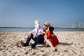 Strange man in funny mask and suit sits with elegant woman in red dress Royalty Free Stock Photo