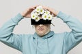 a strange man stands on a light background with a mesh and black glasses covering his eyes, turning his face to the Royalty Free Stock Photo