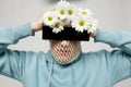 a strange man stands on a light background with a mesh and black glasses covering his eyes, turning his face to the Royalty Free Stock Photo