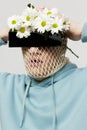 a strange man stands on a light background with a mesh and black glasses covering his eyes, turning his face to the Royalty Free Stock Photo