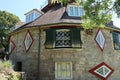 the strange shape of windows of an unusual historic sixteen sided house on a beautiful sunny summers day in Devon, England Royalty Free Stock Photo