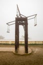 Strange Swing in playground on the mountain terrace behind the mist