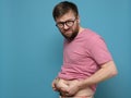 Upset man shows and holds with hands his excess fat on his stomach. Copy space. Overweight person. Healthy lifestyle Royalty Free Stock Photo