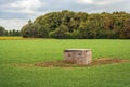 Strange wooden box in the middle of a large lawn