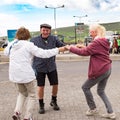 Ireland, seniors spontaneous having fun while dancing to typical irish street music in the streets of Dingle.