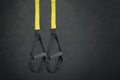 Straps training loop equipment. Black loop functional training equipment on grey background. Sport accessories. Fitness and Gym