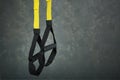 Straps training loop equipment. Black loop functional training equipment on grey background. Sport accessories. Fitness and Gym