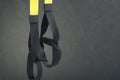 Straps training loop equipment. Black loop functional training equipment on grey background. Sport accessories. Fitness and Gym