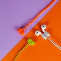 Straps for wireless headphones on colorful paper background Royalty Free Stock Photo
