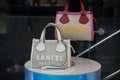 Closeup of colorful leather handbags by Lancel, the famous luxury french brand in a fashion store showroom