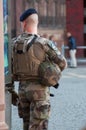 military man standing in the street whit shotgun