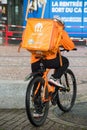 Delivery man standing with smartphone in the street, just eat is a british delivery company in mountain bike