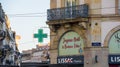 Green pharmacy drug store signage neon sign on the facade of French haussmannian