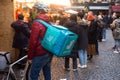deliveroo man standing at the christmas market in the street