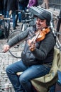 Portrait of smiling violinist playing in the street