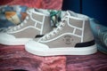 Closeup of beige sneakers by hermes in a fashion strore showroom