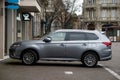 Profile view of grey Mitshubishi outlander parked in the street