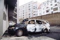 Empty street with burnt car as Vandals in Strasbourg, France, marked the start