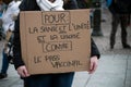 People protesting against the sanitary pass with text in french : Contre le pass vaccinal, in english : against the vaccine pass Royalty Free Stock Photo