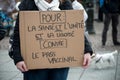 People protesting against the sanitary pass with text in french : contre le pass vaccinal, in english : against the vaccinal pass Royalty Free Stock Photo